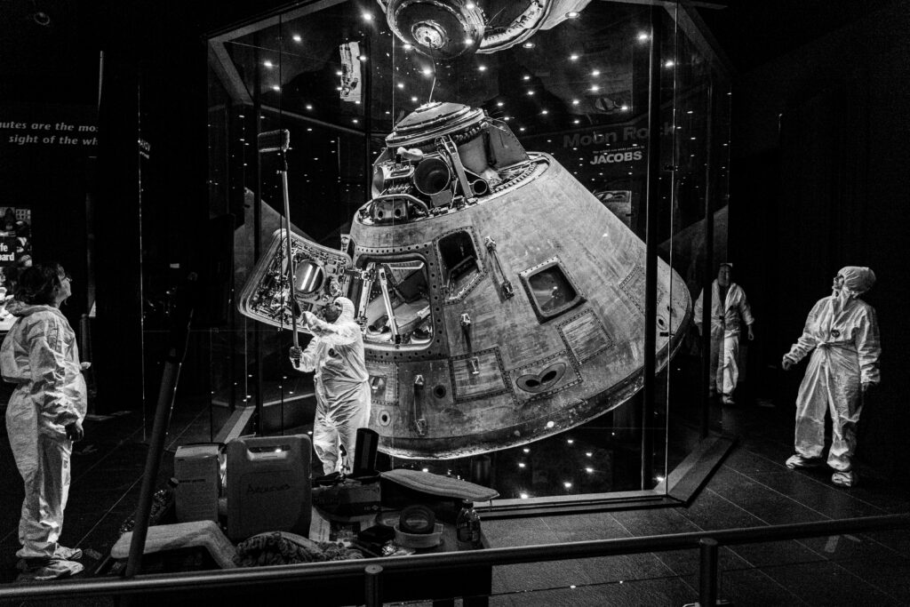 our archives team working together to clean the Apollo capsule in the Davidson Center