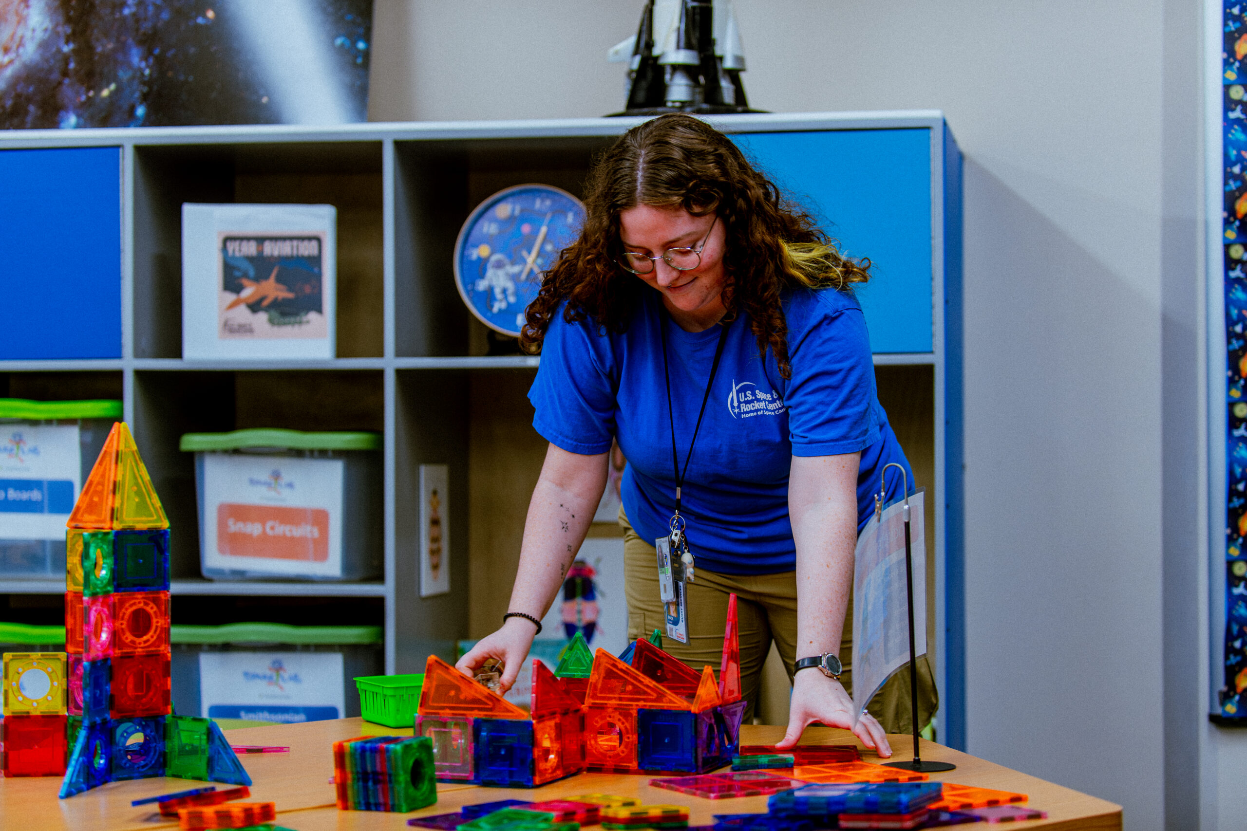 staff member in the Spark!Lab working on one of the activities in the lab