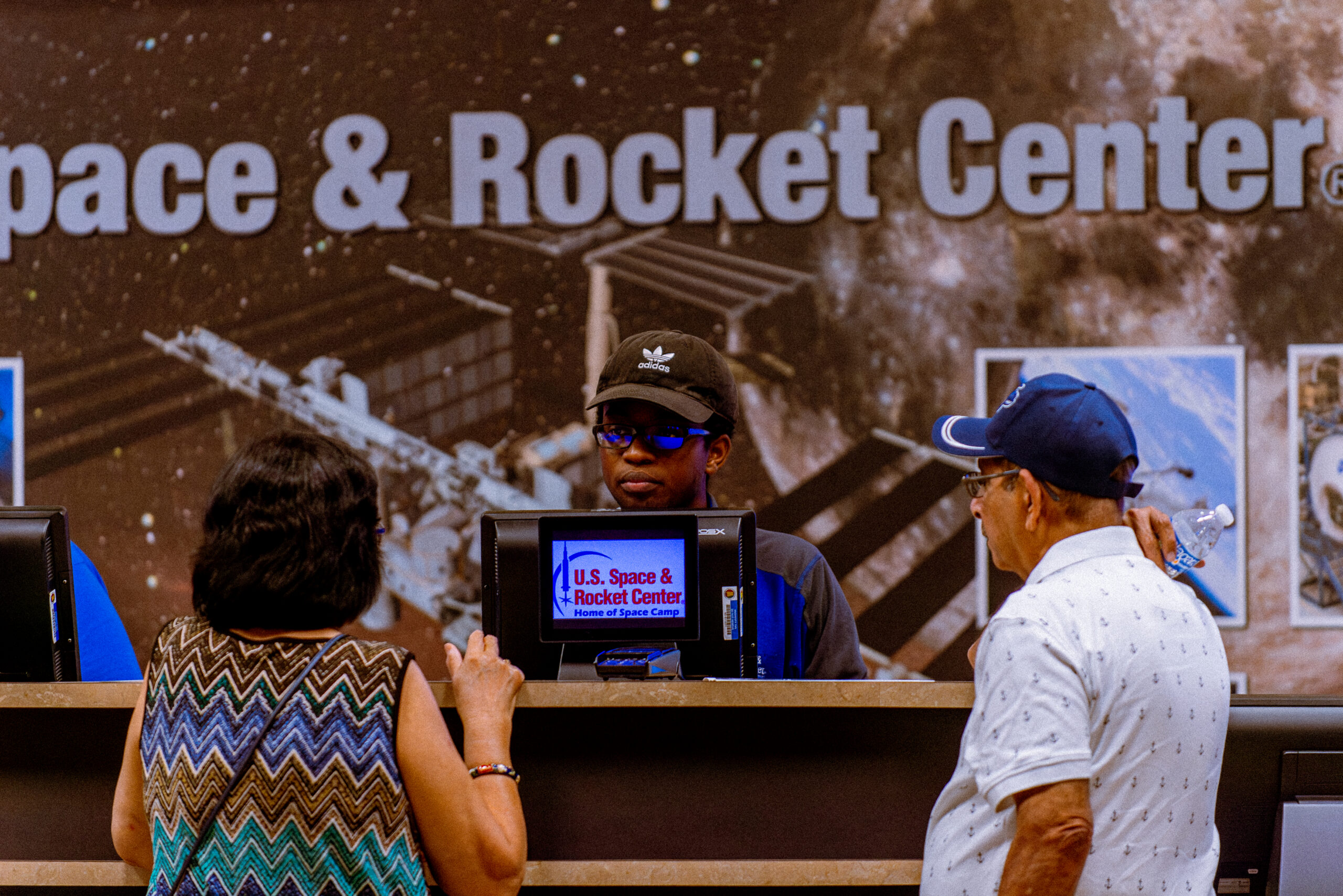 Staff member helping guest while they are purchasing their tickets.