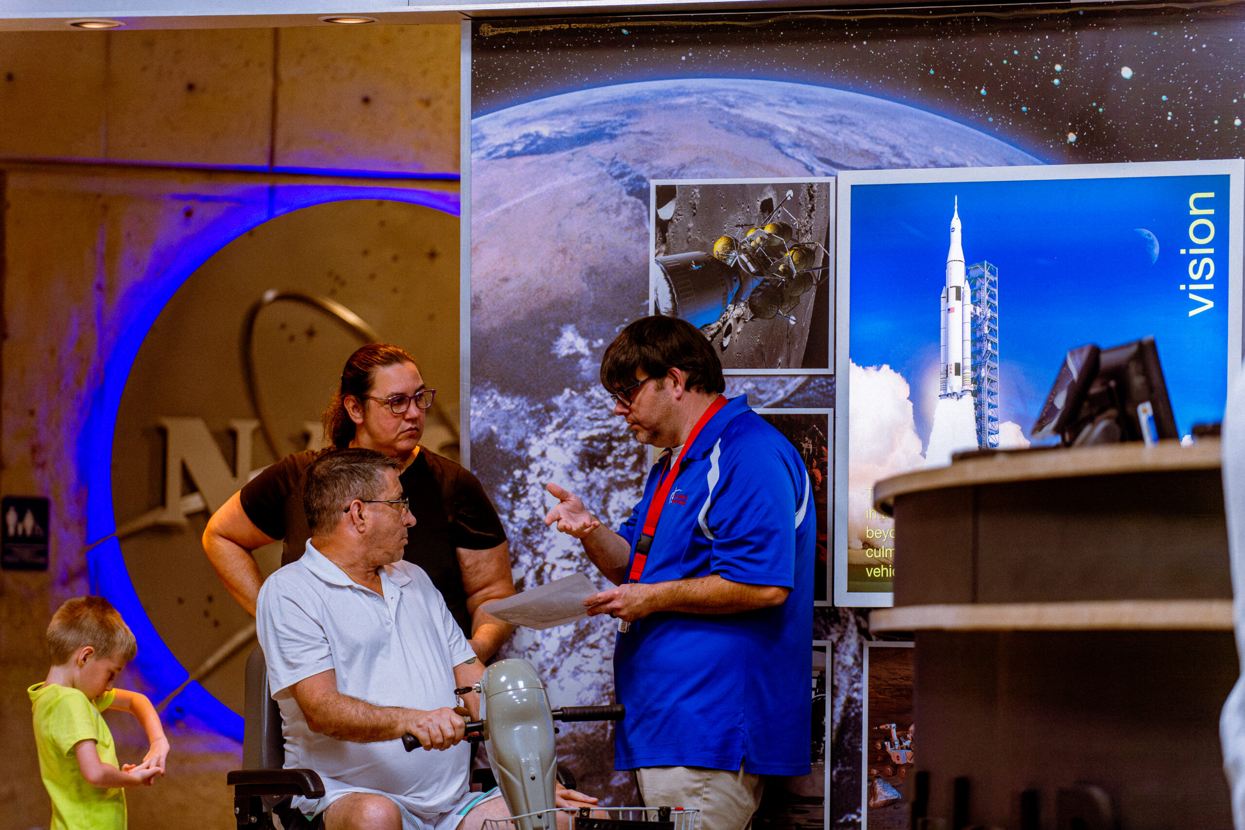Staff member assisting a family with questions they may have about visiting our museum