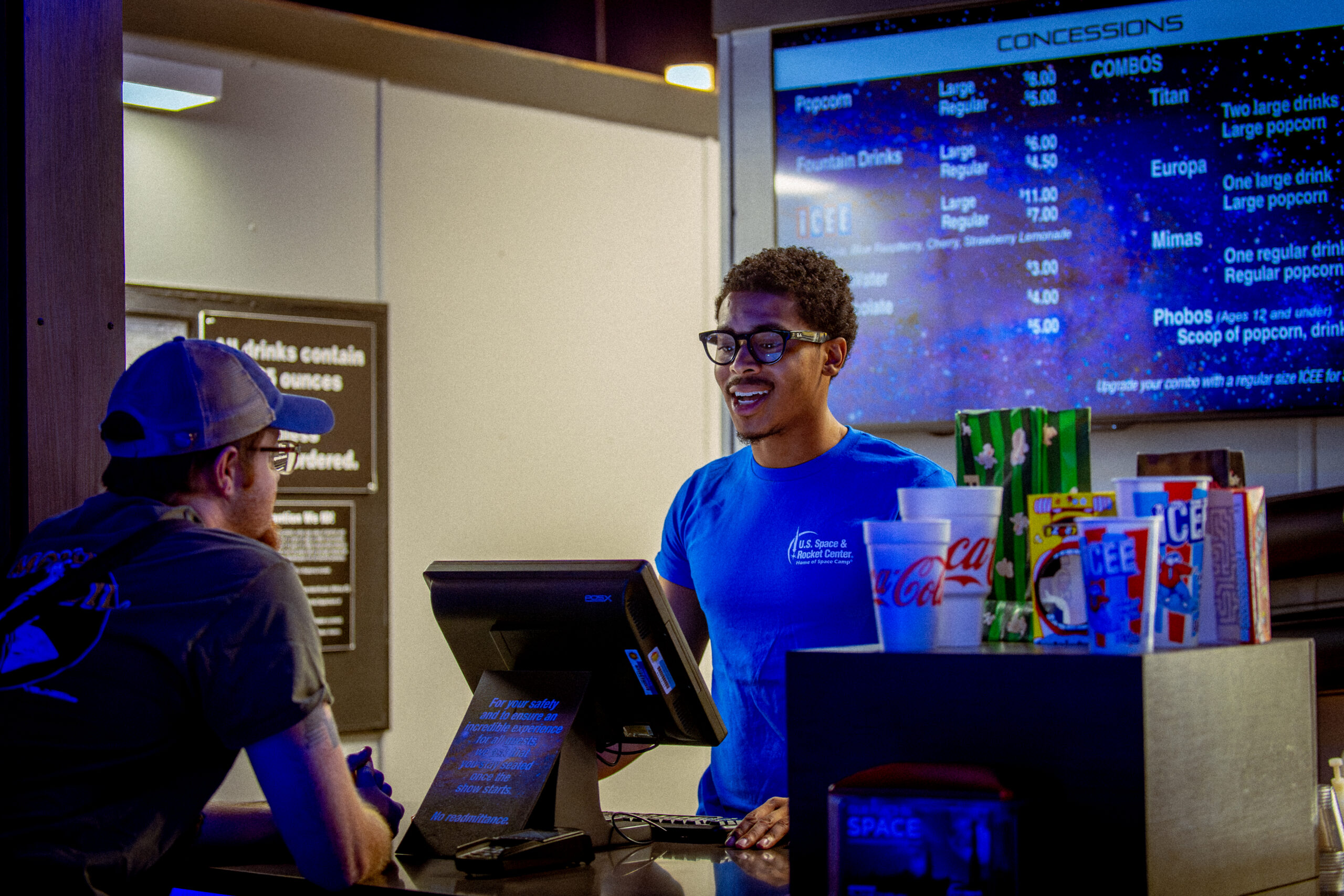 	employees of the Space & Rocket Center communicating to each other at the INTUITIVE Planetarium cash register.