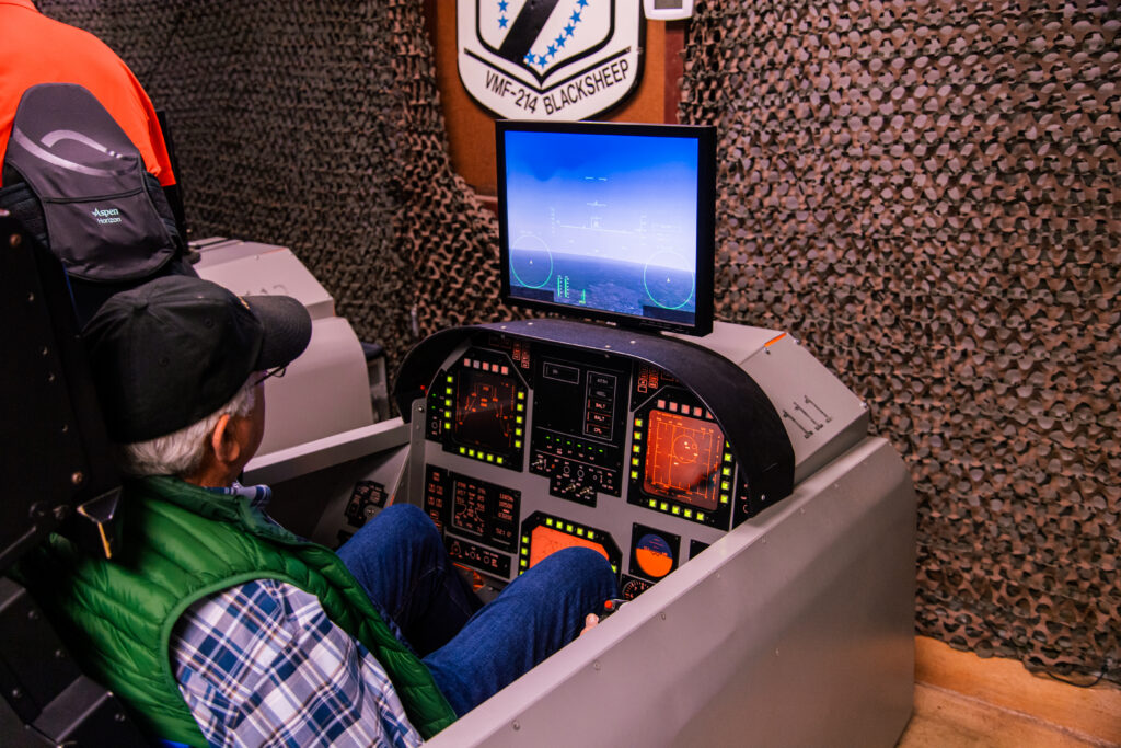 an adult male in the flight sims during his aviation challenge camp