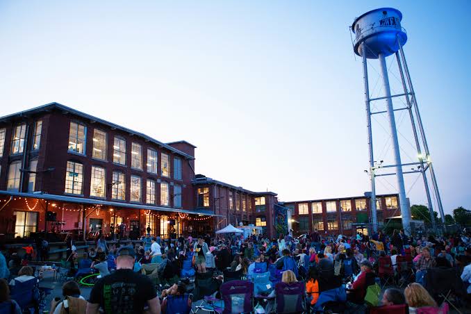 A group of people gathered together at Lowe Mill in Huntsville.