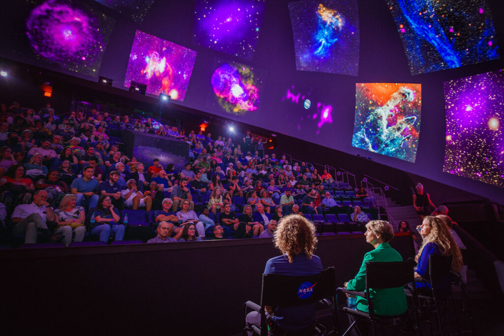 Planetarium team speaking with a group of guests who are attending a domecast event in the INTUITIVE Planetarium