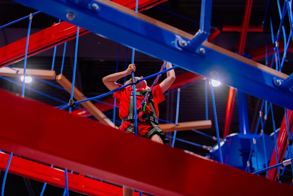 Trainee climbing the Summit Ropes Course.