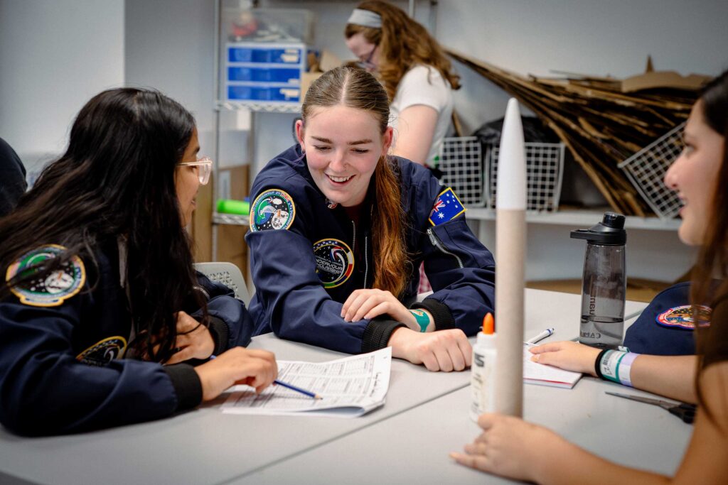 a group of Endeavour scholarship campers working together to solve their mission
