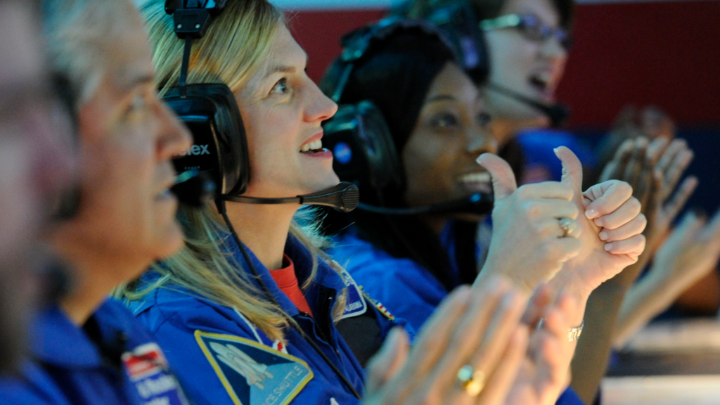 a group of adults in flight suits working together to accomplish their mission in their custom groups program
