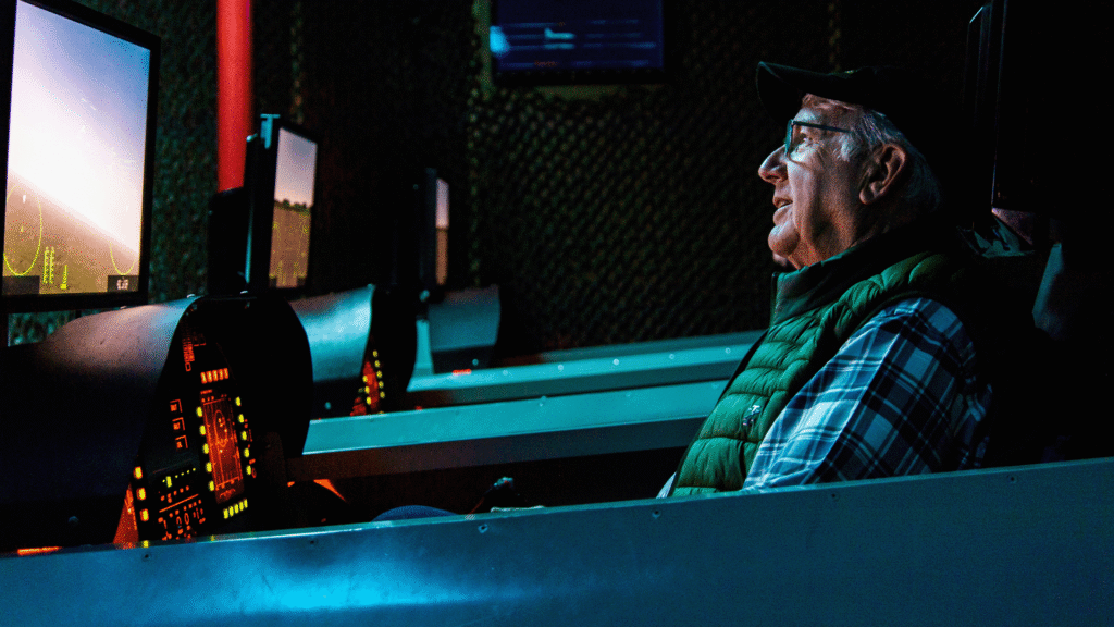 an adult male in the flight sims during his aviation challenge camp