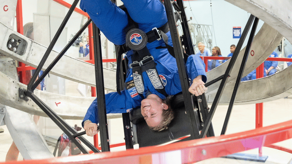 Adult trainee upside down in the multi-axis trainer