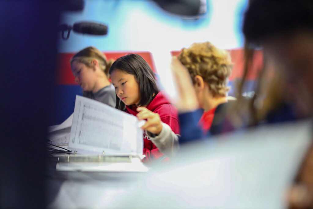 Young students turning pages