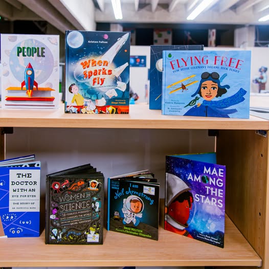 Space-themed children's books on display at Spark!Lab